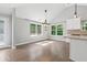 Bright dining area with large windows and hardwood floors, adjoining a modern kitchen at 2565 Aaron Ct, Loganville, GA 30052