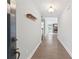 Inviting entryway featuring hardwood floors, coat rack, and an open view to the living room with fireplace at 2565 Aaron Ct, Loganville, GA 30052