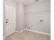 Laundry room with door to outside and wire rack for additional storage at 2565 Aaron Ct, Loganville, GA 30052