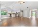 Open-concept living space with hardwood floors, white kitchen with stainless appliances, and an abundance of natural light at 2565 Aaron Ct, Loganville, GA 30052
