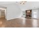 Living room showcasing a vaulted ceiling, stone fireplace, hardwood floors, and access to the outdoor space at 2565 Aaron Ct, Loganville, GA 30052