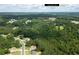 A neighborhood surrounded by lush greenery, with proximity to Lawrenceville, as seen from an aerial view at 2565 Aaron Ct, Loganville, GA 30052