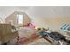 Cozy finished attic space with comfortable seating and a small window at 2645 Barkley Manor Dr, Lawrenceville, GA 30044