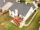 Aerial view of the home's backyard with a wooden deck and patio, surrounded by a well-maintained lawn at 2645 Barkley Manor Dr, Lawrenceville, GA 30044