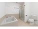 Bright bathroom featuring a soaking tub and separate glass-enclosed shower at 2645 Barkley Manor Dr, Lawrenceville, GA 30044
