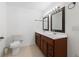 Bathroom featuring double sinks, wood vanity, and toilet with tiled floors at 2645 Barkley Manor Dr, Lawrenceville, GA 30044