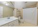 Bright bathroom featuring a large mirror, white vanity, and a shower-tub combination at 2645 Barkley Manor Dr, Lawrenceville, GA 30044