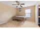 Modest bedroom featuring neutral walls, ceiling fan, and a small window for natural light at 2645 Barkley Manor Dr, Lawrenceville, GA 30044