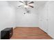 Simple bedroom with wood floors, white walls, ceiling fan, and a closet door at 2645 Barkley Manor Dr, Lawrenceville, GA 30044
