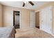 Neutral bedroom featuring tan walls, carpet, a ceiling fan, and white doors at 2645 Barkley Manor Dr, Lawrenceville, GA 30044