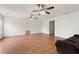 Open living room with wood floors, a ceiling fan, and a brown sofa at 2645 Barkley Manor Dr, Lawrenceville, GA 30044