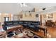 Comfortable living room featuring tile floors, a large leather sectional, and plenty of natural light at 2645 Barkley Manor Dr, Lawrenceville, GA 30044