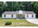 Charming single-story home features a well-maintained lawn and classic white siding and stone accents at 3385 Huntington Ct, Douglasville, GA 30134