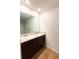 Bathroom features dual sinks, granite countertops, dark wood cabinets and wood-look flooring at 89 Cowpen Ct, Covington, GA 30014