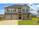 Charming two-story home featuring a two-car garage, neutral color palette, and well-manicured lawn at 89 Cowpen Ct, Covington, GA 30014