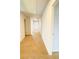 Upstairs hallway with carpet flooring, neutral paint, and a bright window at the end at 89 Cowpen Ct, Covington, GA 30014