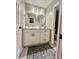 Updated bathroom boasts a white vanity with modern fixtures, complemented by stylish mirrors and decor at 1044 Mariners Ct, Stone Mountain, GA 30083