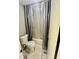 Cozy bathroom featuring a toilet, shower with a curtain, and neutral tones at 1044 Mariners Ct, Stone Mountain, GA 30083
