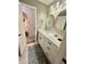 Bathroom featuring a vanity with modern hardware, stylish mirrors, and neutral-toned walls at 1044 Mariners Ct, Stone Mountain, GA 30083