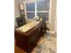 Office space with a traditional desk, a comfortable leather chair, and natural light from the window at 1044 Mariners Ct, Stone Mountain, GA 30083