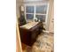 Office space with a traditional desk, a comfortable leather chair, and natural light from the window at 1044 Mariners Ct, Stone Mountain, GA 30083