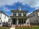 Charming two-story home featuring a brick facade, black shutters, and a welcoming front porch at 163 Basil St, Cumming, GA 30040