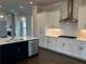 Stylish kitchen features stainless steel appliances, a center island, and white cabinetry at 163 Basil St, Cumming, GA 30040