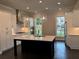 Bright kitchen with center island, stainless appliances, pendant lights, and white cabinets at 163 Basil St, Cumming, GA 30040