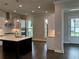 Modern kitchen featuring white cabinetry, stainless steel appliances, and dark hardwood floors at 163 Basil St, Cumming, GA 30040