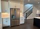 Spacious kitchen features stainless refrigerator, white cabinets, stone countertops, and stylish lighting at 163 Basil St, Cumming, GA 30040