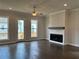 Bright living room with fireplace, hardwood floors, and access to outdoor living space at 163 Basil St, Cumming, GA 30040