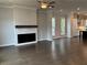 Living room featuring hardwood floors, a fireplace, and an open view to the kitchen at 163 Basil St, Cumming, GA 30040
