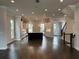 Open concept living space with hardwood floors, natural light, and a modern kitchen at 163 Basil St, Cumming, GA 30040