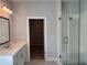 Main bathroom with glass shower, vanity, and view to walk-in closet at 163 Basil St, Cumming, GA 30040