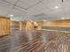 Finished basement with a drop ceiling, unique floors and wood paneled walls at 2259 Eastway Rd, Decatur, GA 30033