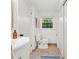 Bright bathroom featuring tile floors, modern toilet, a large window and vanity at 2259 Eastway Rd, Decatur, GA 30033