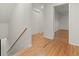 Upstairs hallway featuring hardwood floors and neutral walls with multiple closets and doorways at 2259 Eastway Rd, Decatur, GA 30033
