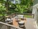 Elevated wooden deck featuring outdoor seating and a beautifully landscaped backyard at 2259 Eastway Rd, Decatur, GA 30033