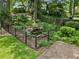 Backyard view featuring a serene pond enclosed by a decorative fence, adding a touch of nature to the property at 2259 Eastway Rd, Decatur, GA 30033