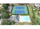 An aerial view of a community pool and tennis courts surrounded by lush landscaping and trees at 3450 Merganser Ln, Alpharetta, GA 30022