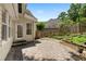 Backyard brick patio with a door leading to the house and a wooden fence, great for relaxation and entertaining at 3450 Merganser Ln, Alpharetta, GA 30022