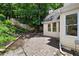 Inviting backyard with a brick patio, lush landscaping, and a cozy fire pit area perfect for outdoor gatherings at 3450 Merganser Ln, Alpharetta, GA 30022