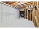 Unfinished basement with concrete wall and exposed wood framing, offering ample storage space and customization potential at 3450 Merganser Ln, Alpharetta, GA 30022