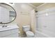 Simple bathroom with a shower-tub combo, toilet, and a round mirror above the vanity at 3450 Merganser Ln, Alpharetta, GA 30022