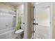 Bathroom featuring a shower-tub combo, white tile, and a green patterned shower curtain at 3450 Merganser Ln, Alpharetta, GA 30022