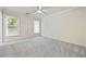 Spacious bedroom featuring two windows, neutral carpet, and a ceiling fan at 3450 Merganser Ln, Alpharetta, GA 30022