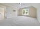 A spacious, carpeted bedroom with a ceiling fan and plenty of natural light from the large window at 3450 Merganser Ln, Alpharetta, GA 30022