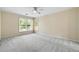 Spacious bedroom with carpet, two large windows, and a ceiling fan at 3450 Merganser Ln, Alpharetta, GA 30022