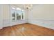 Dining room featuring hardwood floors, classic trim, a chandelier, and bright windows at 3450 Merganser Ln, Alpharetta, GA 30022