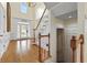 A grand entrance foyer boasts a hardwood floor, staircase, and elegant decor at 3450 Merganser Ln, Alpharetta, GA 30022